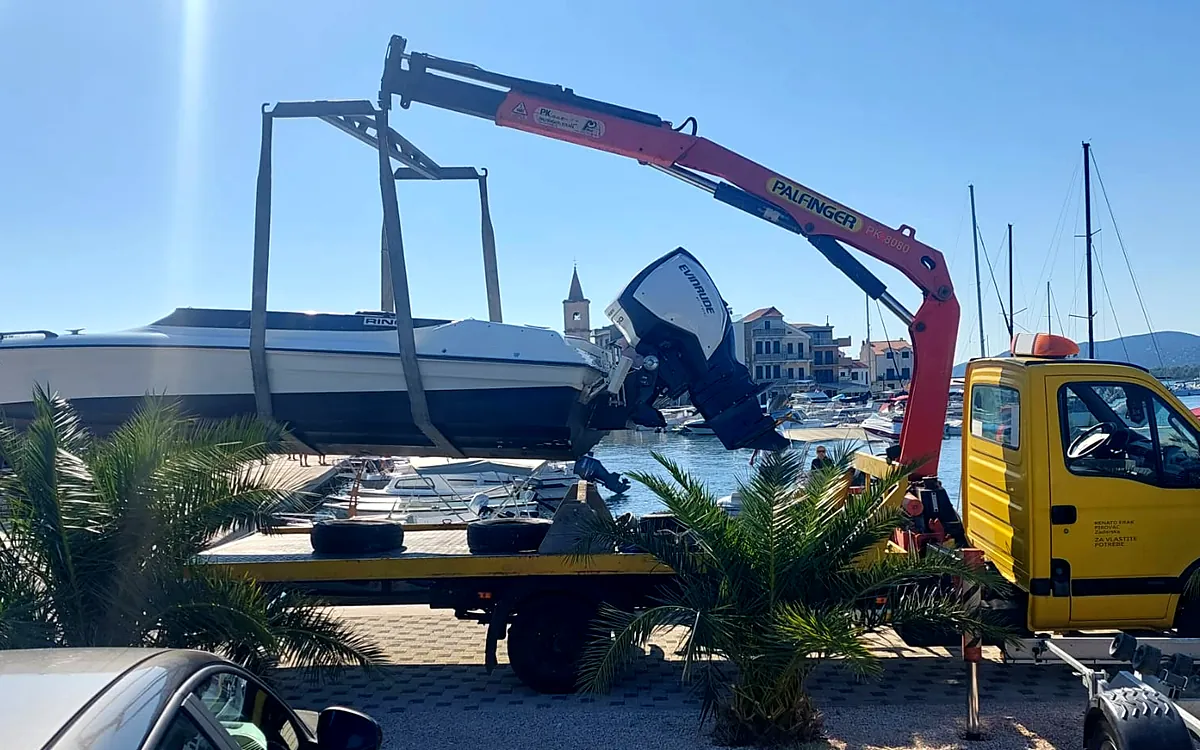 Speedboat in the slings of the truck crane on the Pirovac waterfront